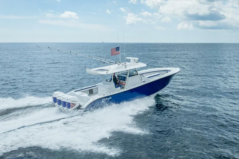 Slide: The Image of 2023 Yellowfin 39 Offshore boat cruising on open ocean with American flag. - 27