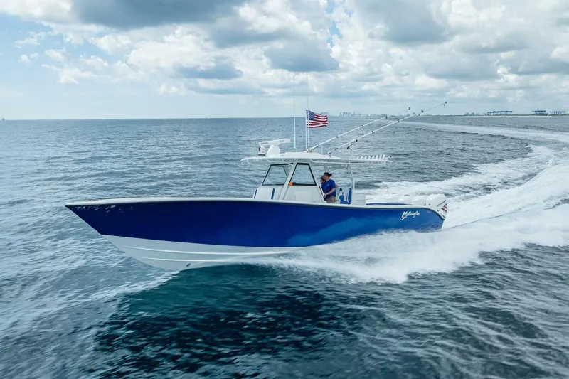 Slide: The Image of 2023 Yellowfin 39 Offshore boat cruising on open water under cloudy sky. - 21