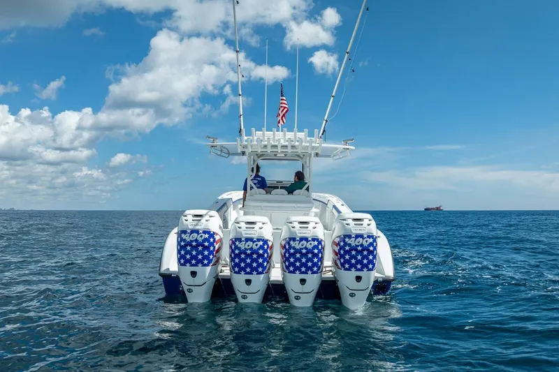 Slide: The Image of 2023 Yellowfin 39 Offshore boat with four powerful outboard engines on open sea. - 2
