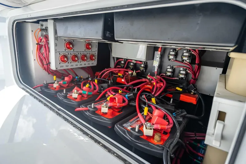 Slide: The Image of 2023 Yellowfin 39 Offshore boat battery compartment with wiring and switches. - 56