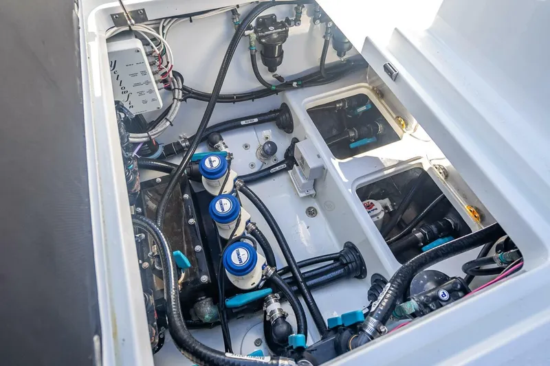 Slide: The Image of 2023 Yellowfin 39 Offshore boat engine compartment with visible wiring and components. - 36
