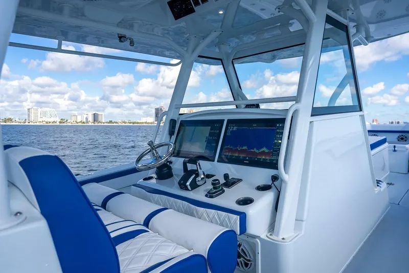 Slide: The Image of 2023 Yellowfin 39 Offshore boat cockpit with modern navigation displays and ocean view. - 46