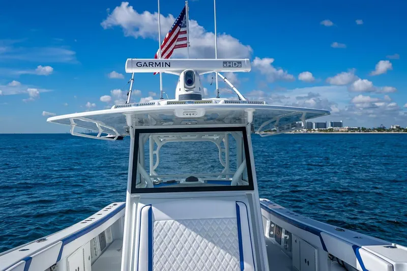 Slide: The Image of 2023 Yellowfin 39 Offshore boat on open sea with clear blue sky. - 44