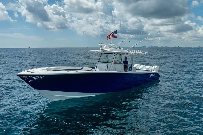 Slide: The Image of 2023 Yellowfin 39 Offshore boat on open sea under cloudy sky. - 12