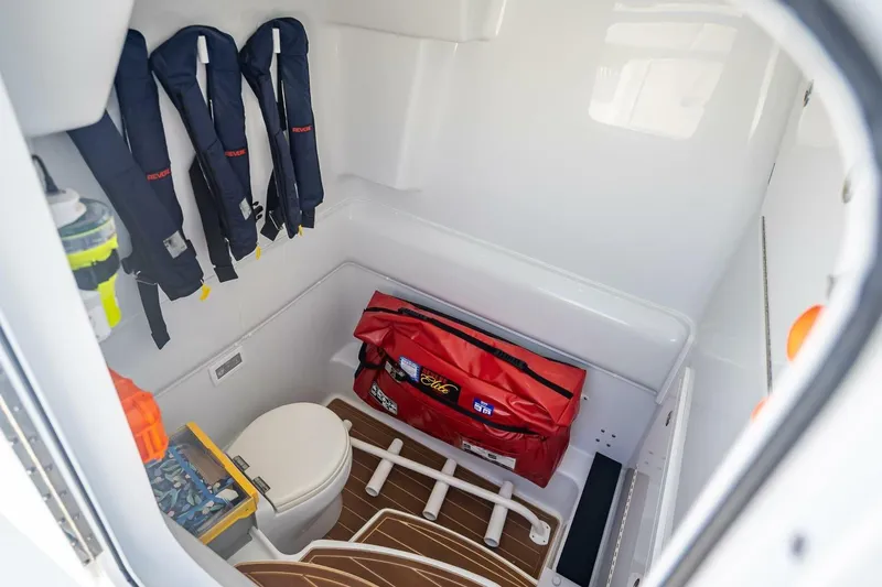 Slide: The Image of 2023 Yellowfin 39 Offshore cabin with life jackets, toilet, and safety gear. - 35