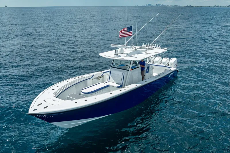 Slide: The Image of 2023 Yellowfin 39 Offshore boat cruising on open ocean with American flag. - 11