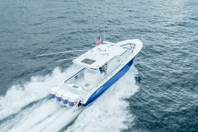 Slide: The Image of 2023 Yellowfin 39 Offshore boat cruising on open water, aerial view. - 31