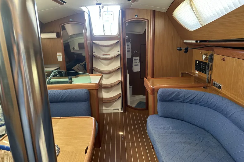 Slide: The Image of Interior of 2007 Jeanneau Sun Odyssey 39 DS sailboat with wood finish and blue seating. - 18