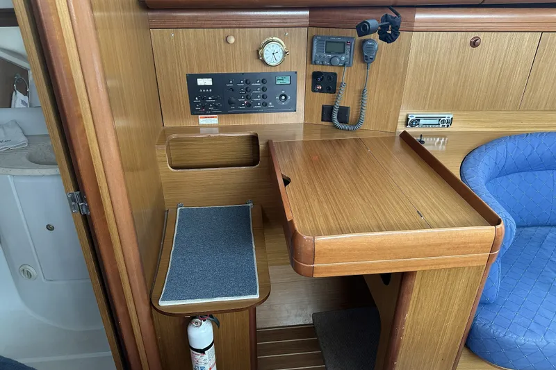 Slide: The Image of Navigation station of 2007 Jeanneau Sun Odyssey 39 DS yacht with control panel and seating. - 21