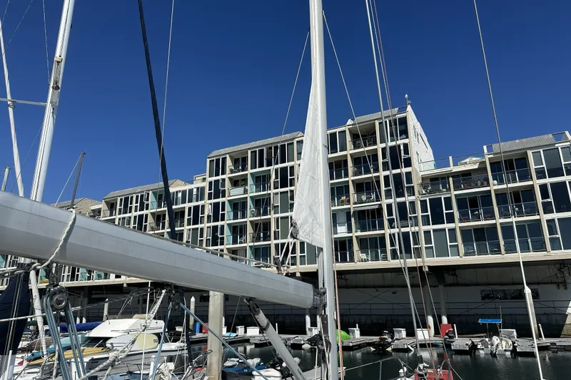 Slide: The Image of Sailboat Jeanneau Sun Odyssey 39 DS, 2007, docked near modern waterfront buildings. - 16