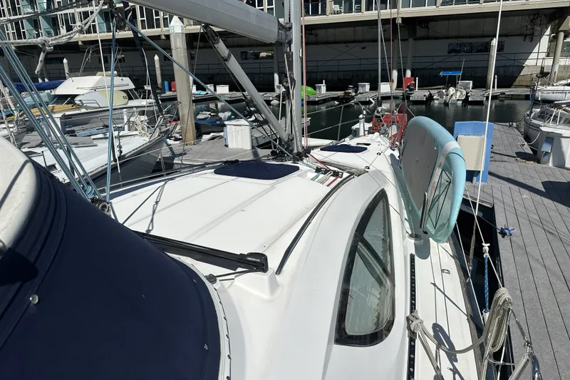 Slide: The Image of 2007 Jeanneau Sun Odyssey 39 DS sailboat docked at marina, showcasing deck and rigging. - 15