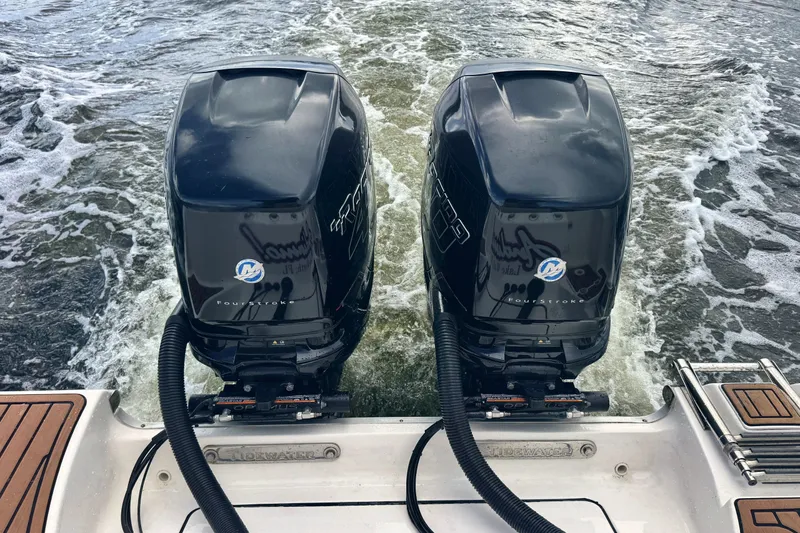 Slide: The Image of Twin outboard motors on a 2019 Tidewater 320 CC Adventure boat in motion. - 33