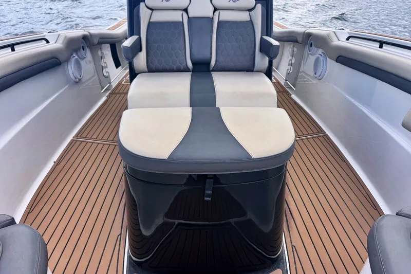 Slide: The Image of 2019 Tidewater 320 CC Adventure boat interior with cushioned seating and teak flooring. - 20