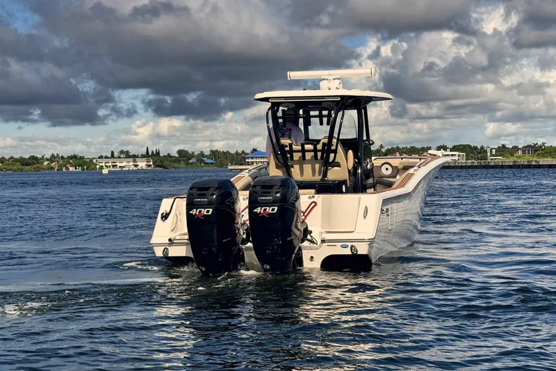 Slide: The Image of 2019 Tidewater 320 CC Adventure boat with dual 400 horsepower engines on open water. - 13