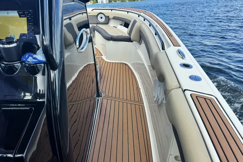 Slide: The Image of 2019 Tidewater 320 CC Adventure boat interior with teak flooring and modern dashboard. - 19