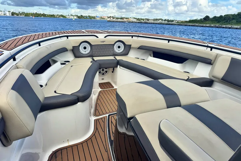 Slide: The Image of 2019 Tidewater 320 CC Adventure boat interior with luxurious seating and wood accents. - 14