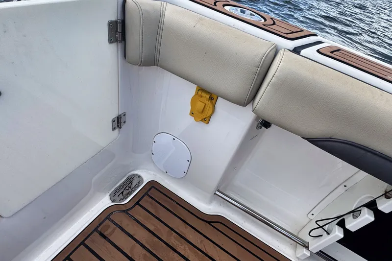 Slide: The Image of 2019 Tidewater 320 CC Adventure boat interior with cushioned seating and teak flooring. - 28