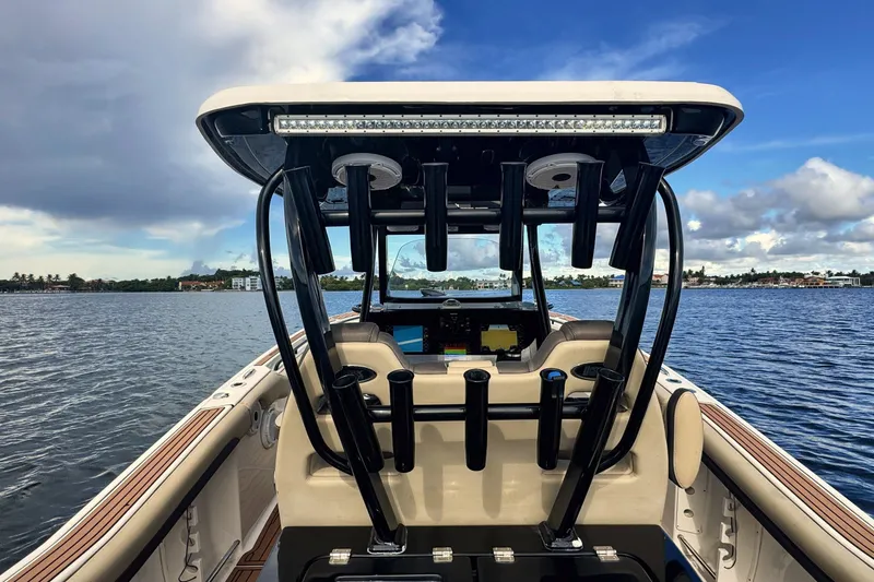Slide: The Image of 2019 Tidewater 320 CC Adventure boat on calm water under a partly cloudy sky. - 30