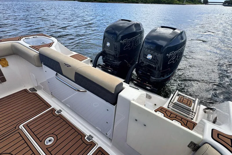 Slide: The Image of 2019 Tidewater 320 CC Adventure boat with twin Racing 400 engines on a calm lake. - 32