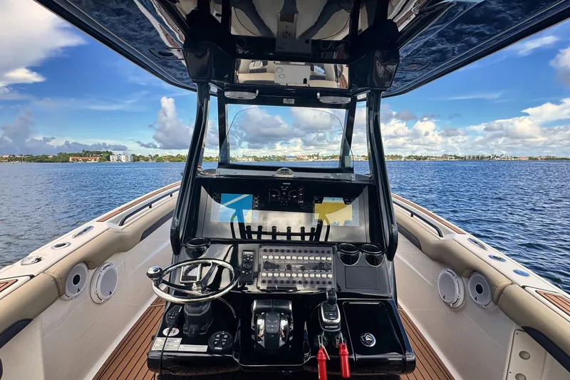Slide: The Image of 2019 Tidewater 320 CC Adventure boat dashboard with scenic ocean view. - 21