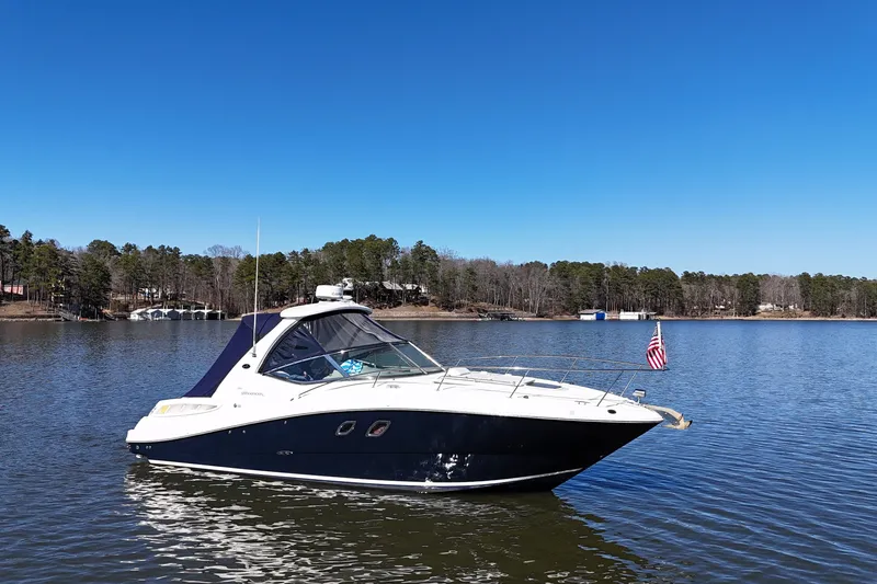 Slide: The Image of 2007 Sea Ray Sundancer 310 boat on a calm lake with clear blue sky. - 10