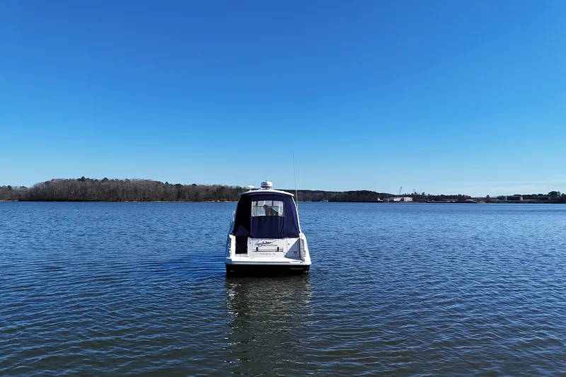 Slide: The Image of 2007 Sea Ray Sundancer 310 boat on calm lake under clear blue sky. - 4