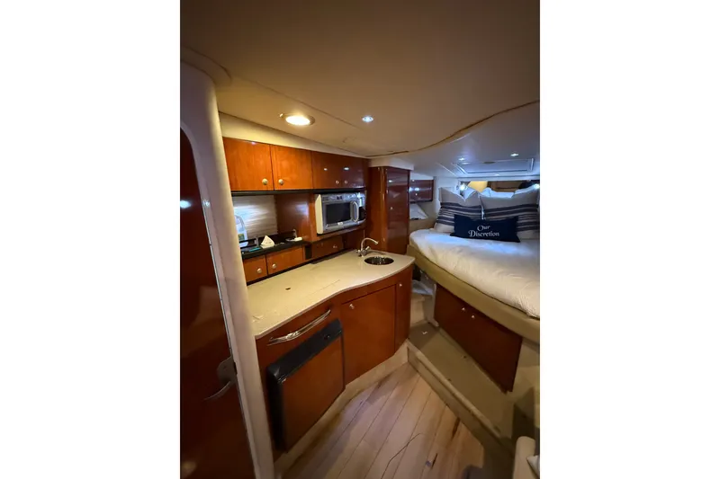 Slide: The Image of 2007 Sea Ray Sundancer 310 interior with kitchenette and cozy sleeping area. - 21