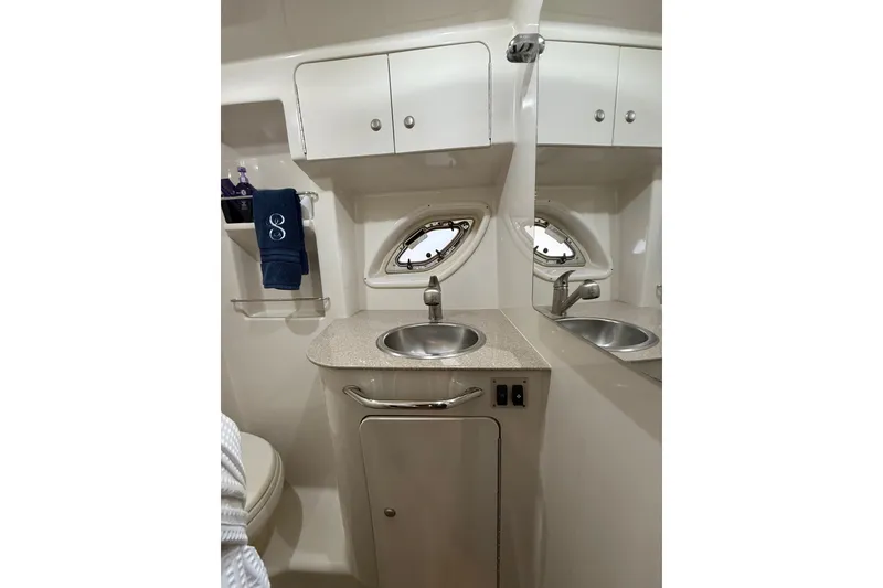 Slide: The Image of 2007 Sea Ray Sundancer 310 bathroom with sink, mirror, and storage cabinets. - 28