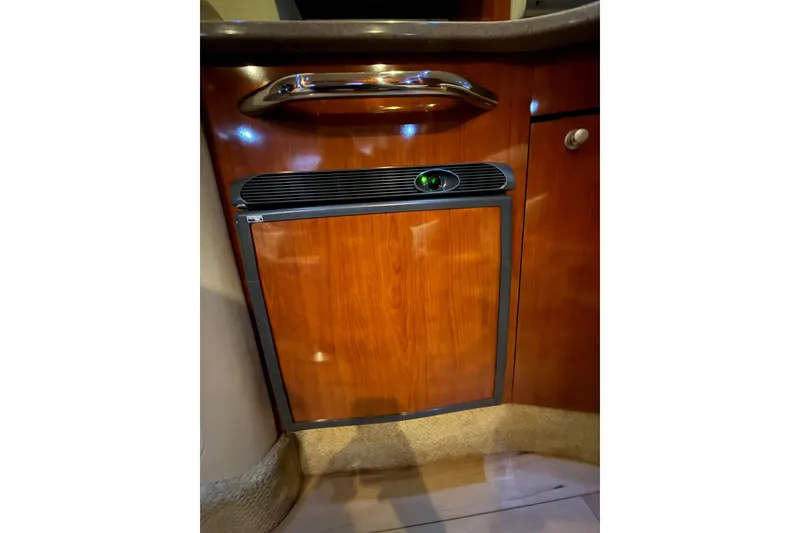 Slide: The Image of Wood-paneled mini fridge in 2007 Sea Ray Sundancer 310 yacht interior. - 24