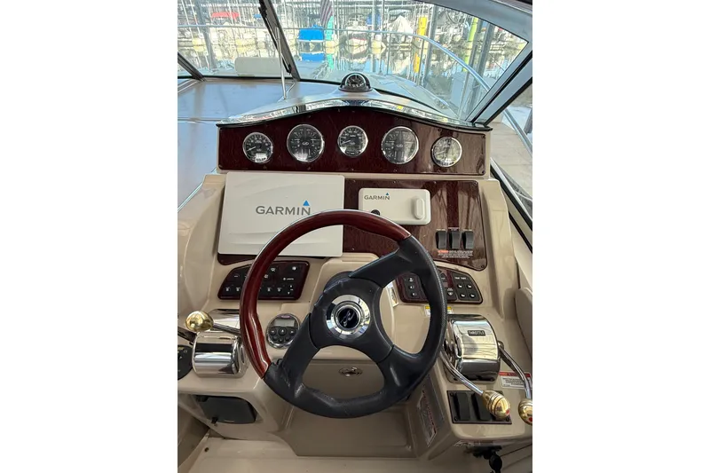Slide: The Image of Helm of 2007 Sea Ray Sundancer 310 with Garmin navigation system and classic gauges. - 14