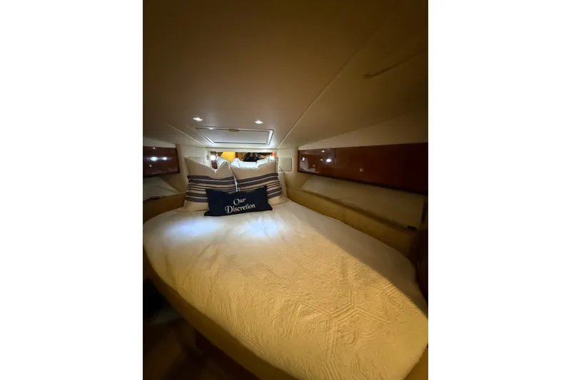 Slide: The Image of Interior cabin of 2007 Sea Ray Sundancer 310 with cozy bedding and ambient lighting. - 25