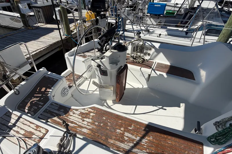 Slide: The Image of Cockpit of 2003 Beneteau Oceanis 393 sailboat with wooden seating and steering wheel. - 3