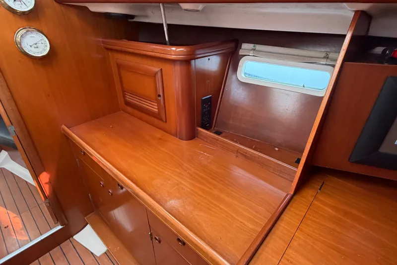 Slide: The Image of Interior of 2003 Beneteau Oceanis 393 sailboat with wooden cabinetry and porthole window. - 20