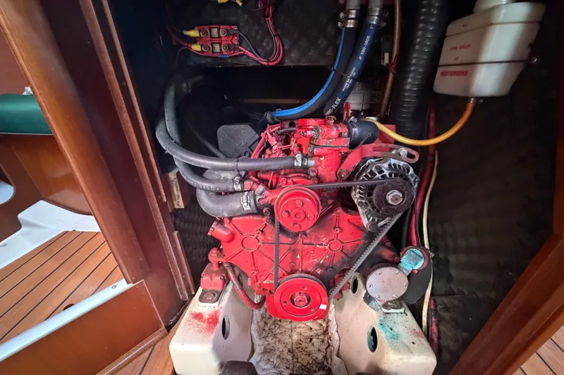 Slide: The Image of Engine compartment of a 2003 Beneteau Oceanis 393 sailboat, showcasing red engine components. - 31