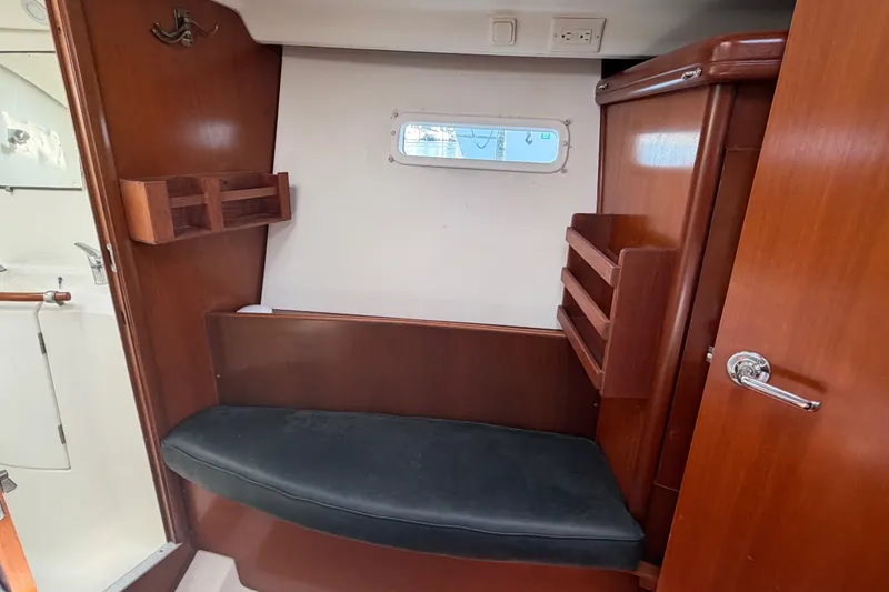 Slide: The Image of Interior of 2003 Beneteau Oceanis 393 sailboat with wooden cabinetry and seating. - 23