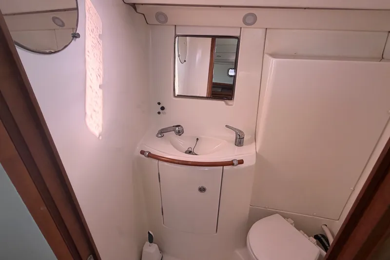 Slide: The Image of Bathroom interior of 2003 Beneteau Oceanis 393 yacht, featuring sink and mirror. - 6