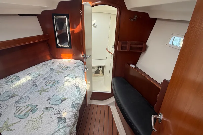 Slide: The Image of Interior cabin of 2003 Beneteau Oceanis 393 sailboat with bed and wooden finish. - 21