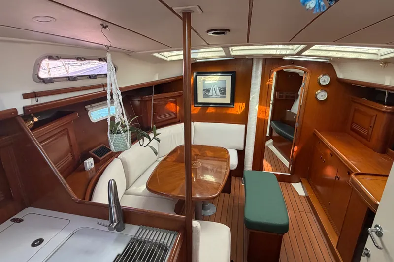 Slide: The Image of Interior of 2003 Beneteau Oceanis 393 yacht with elegant wood finish and cozy seating area. - 4