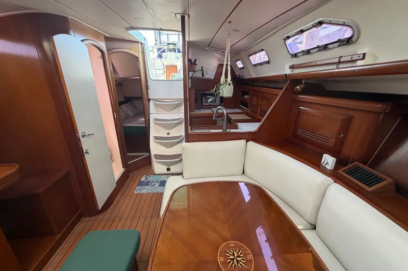Slide: The Image of Interior of 2003 Beneteau Oceanis 393 yacht with wood finish and cozy seating area. - 30