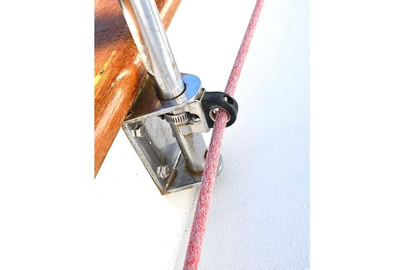 Slide: The Image of Close-up of a 1982 Passport/Hoyt 45 sailboat rigging detail with red rope and metal fitting. - 45