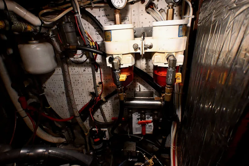 Slide: The Image of Engine room of a 1982 Passport Hoyt 45 sailboat with fuel filters and piping. - 95