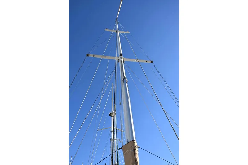 Slide: The Image of Tall sailboat mast against clear blue sky, Passport Hoyt 45, 1982 model. - 8