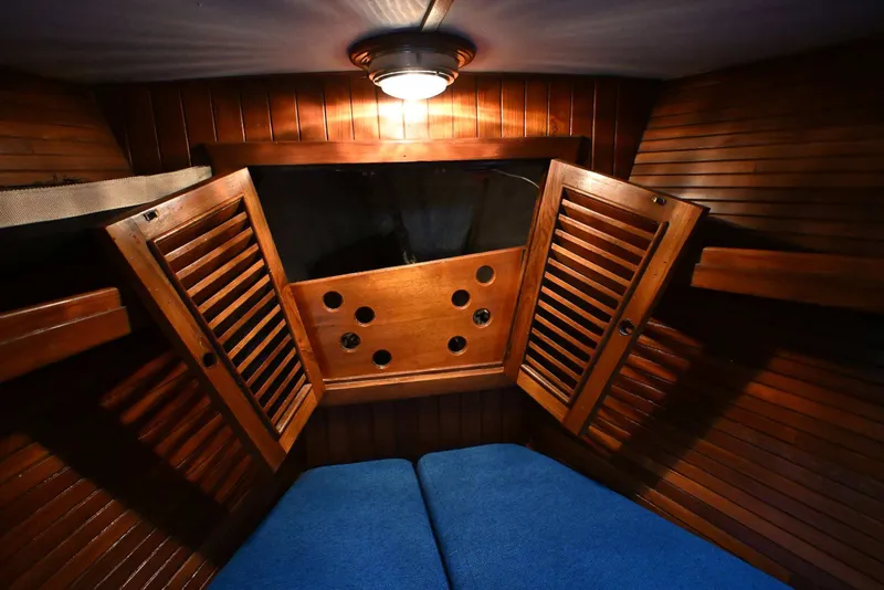 Slide: The Image of Cozy wooden cabin interior of 1982 Passport Hoyt 45 sailboat with blue cushions. - 77