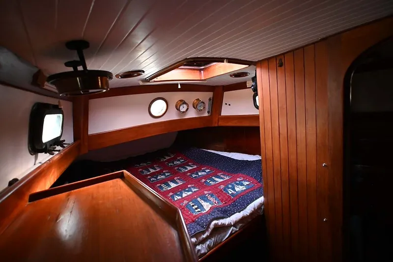 Slide: The Image of Cozy cabin interior of 1982 Passport Hoyt 45 sailboat with nautical-themed bedding. - 64