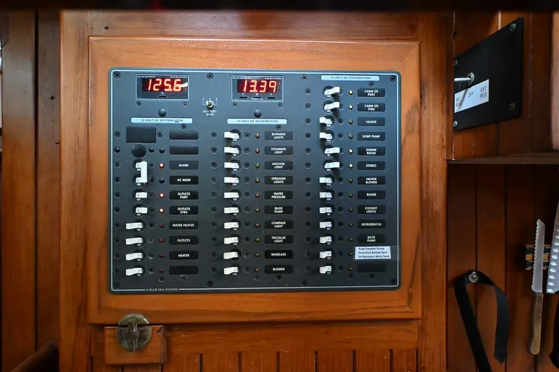 Slide: The Image of Electrical panel on a 1982 Passport / Hoyt 45 sailboat, featuring switches and voltage displays. - 84