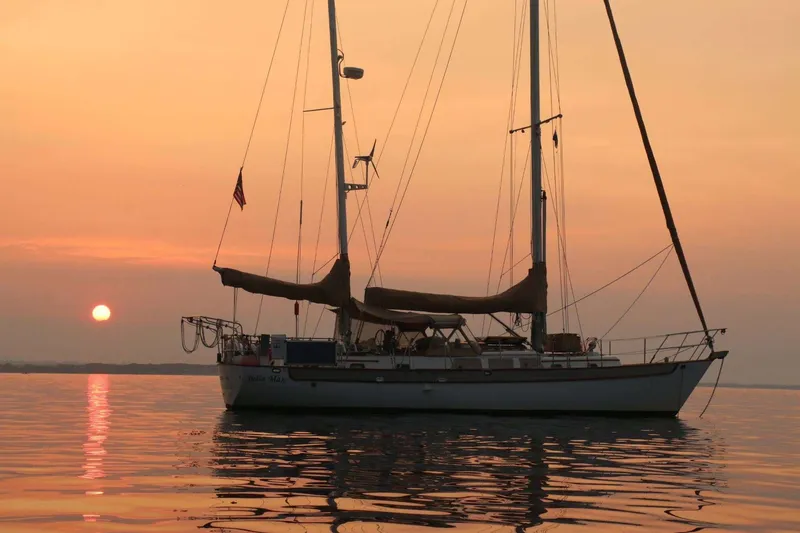 Slide: The Image of Sailboat at sunset on calm waters, Passport Hoyt 45, 1982 model. - 2