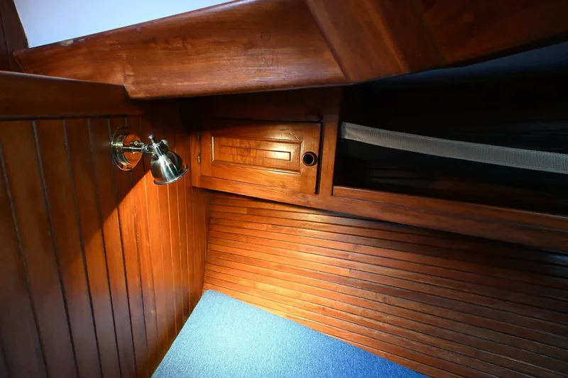 Slide: The Image of Wood-paneled cabin interior of 1982 Passport Hoyt 45 yacht with built-in lighting. - 73