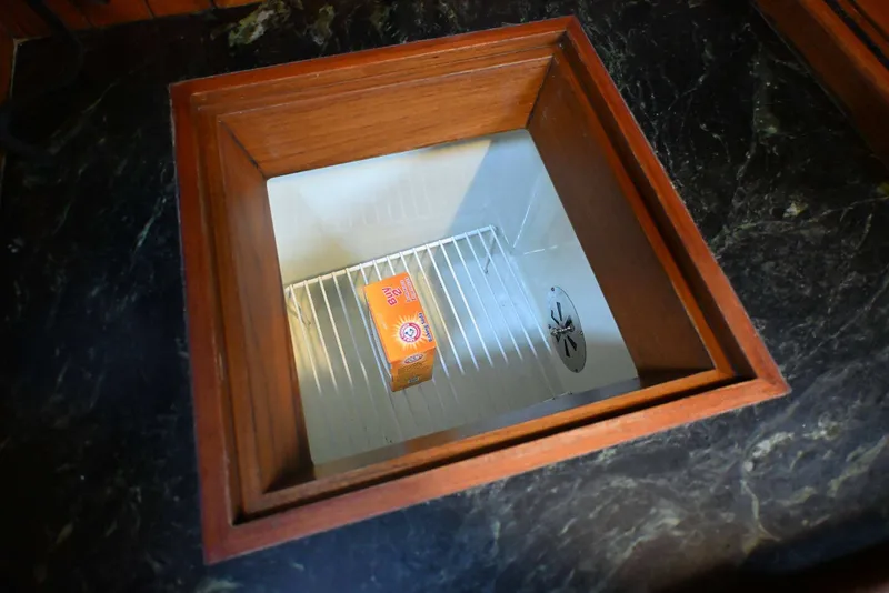 Slide: The Image of Marble countertop with built-in cooler, featuring a box of baking soda inside. - 69