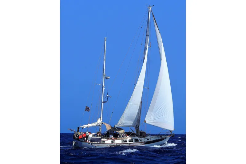 Slide: The Image of Sailing yacht Passport Hoyt 45 from 1982 on open sea with blue sky. - 1
