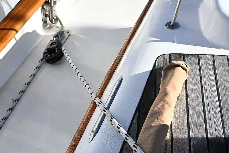 Slide: The Image of Close-up of a 1982 Passport Hoyt 45 sailboat deck with rigging and wood accents. - 15